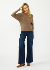 [Color: Mocha] A front facing image of a blonde model wearing a brown pullover sweater with a boat neckline and long sleeves that taper at the cuffs. 