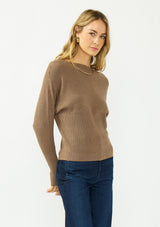 [Color: Mocha] A side facing image of a blonde model wearing a brown pullover sweater with a boat neckline and long sleeves that taper at the cuffs. 