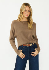 [Color: Mocha] A front facing image of a blonde model wearing a brown pullover sweater with a boat neckline and long sleeves that taper at the cuffs. 