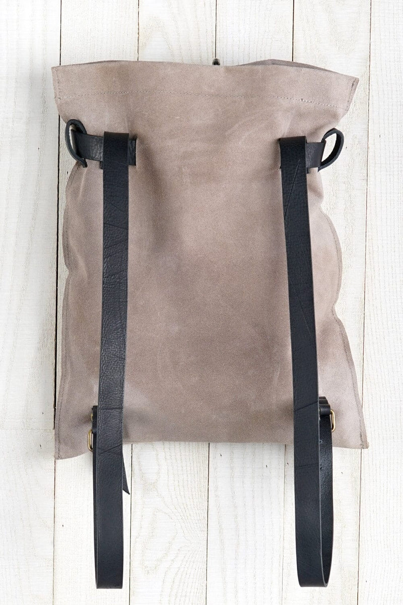 [Color: Sand/Nero] A light grey suede pouch backpack with an adjustable belt closure and leather shoulder straps. 