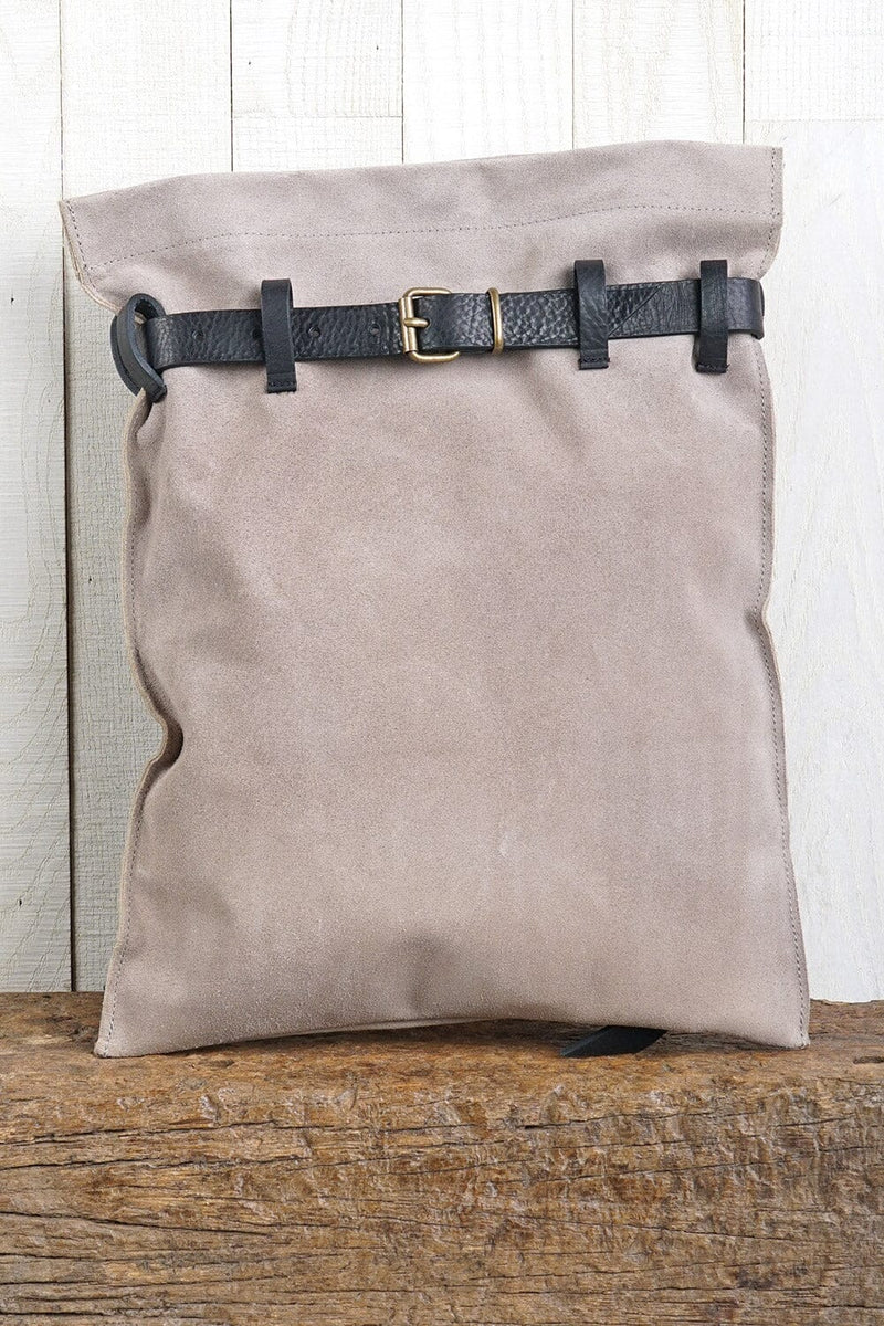 [Color: Sand/Nero] A light grey suede pouch backpack with an adjustable belt closure and leather shoulder straps. 
