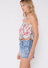 [Color: Raspberry/Mocha/LightBlue] A blonde model wearing a pink floral two piece skirt and tank top set. With a cropped camisole tank top that features spaghetti straps and a ruffled neckline. The mid length skirt features an adjustable waist tie and a tiered hemline. 