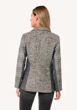 [Color: Cream/Black] A back facing image of a blonde model wearing a classic blazer in a grey patchwork plaid. With a button front, long sleeves, and side flap pockets. 