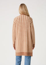 [Color: Taupe/Cream] A back facing image of a blonde model wearing a mid length fuzzy sweater coat in a brown and cream houndstooth plaid design. With long sleeves, an open front, and side patch pockets. 