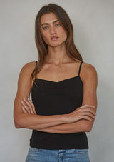 [Color: Black] A front facing image of a brunette model wearing a black jersey cami with a ruched bust and spaghetti straps. 