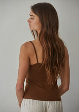 [Color: Brown] A back facing image of a brunette model wearing a brown jersey cami with a ruched bust and spaghetti straps. 