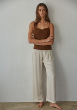 [Color: Brown] A front facing image of a brunette model wearing a brown jersey cami with a ruched bust and spaghetti straps. 