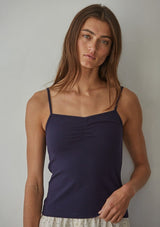 [Color: Navy] A front facing image of a brunette model wearing a navy jersey cami with a ruched bust and spaghetti straps. 