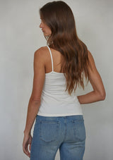 [Color: Off White] A back facing image of a brunette model wearing an off white jersey cami with a ruched bust and spaghetti straps. 