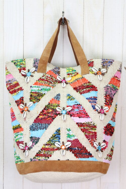 [Color: Multi/Natural] An image of a multi color tote bag with a zigzag pattern and shell accents. 