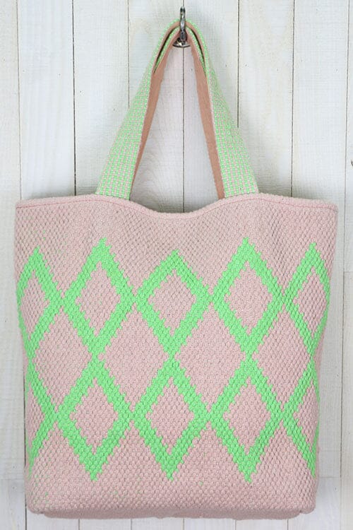 [Color: Petal/Lime] An off white tote bag with a bright green geometric pattern. Features top handles for the shoulder and a playful tassel pom detail. 