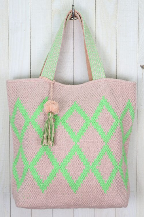 [Color: Petal/Lime] An off white tote bag with a bright green geometric pattern. Features top handles for the shoulder and a playful tassel pom detail. 