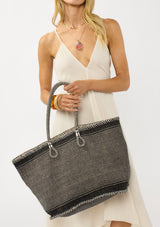 [Color: Black/Natural] A bohemian tote bag in a natural and black texture. With stitched detail throughout, two rope handles, and a top zip closure.