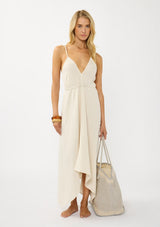 [Color: Blue/Natural] A front facing image of a blonde model holding a bohemian tote bag in a natural and light blue texture. With stitched detail throughout, two rope handles, and a top zip closure.