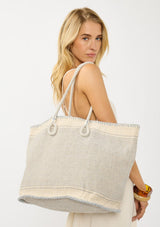 [Color: Blue/Natural] A bohemian tote bag in a natural and light blue texture. With stitched detail throughout, two rope handles, and a top zip closure.