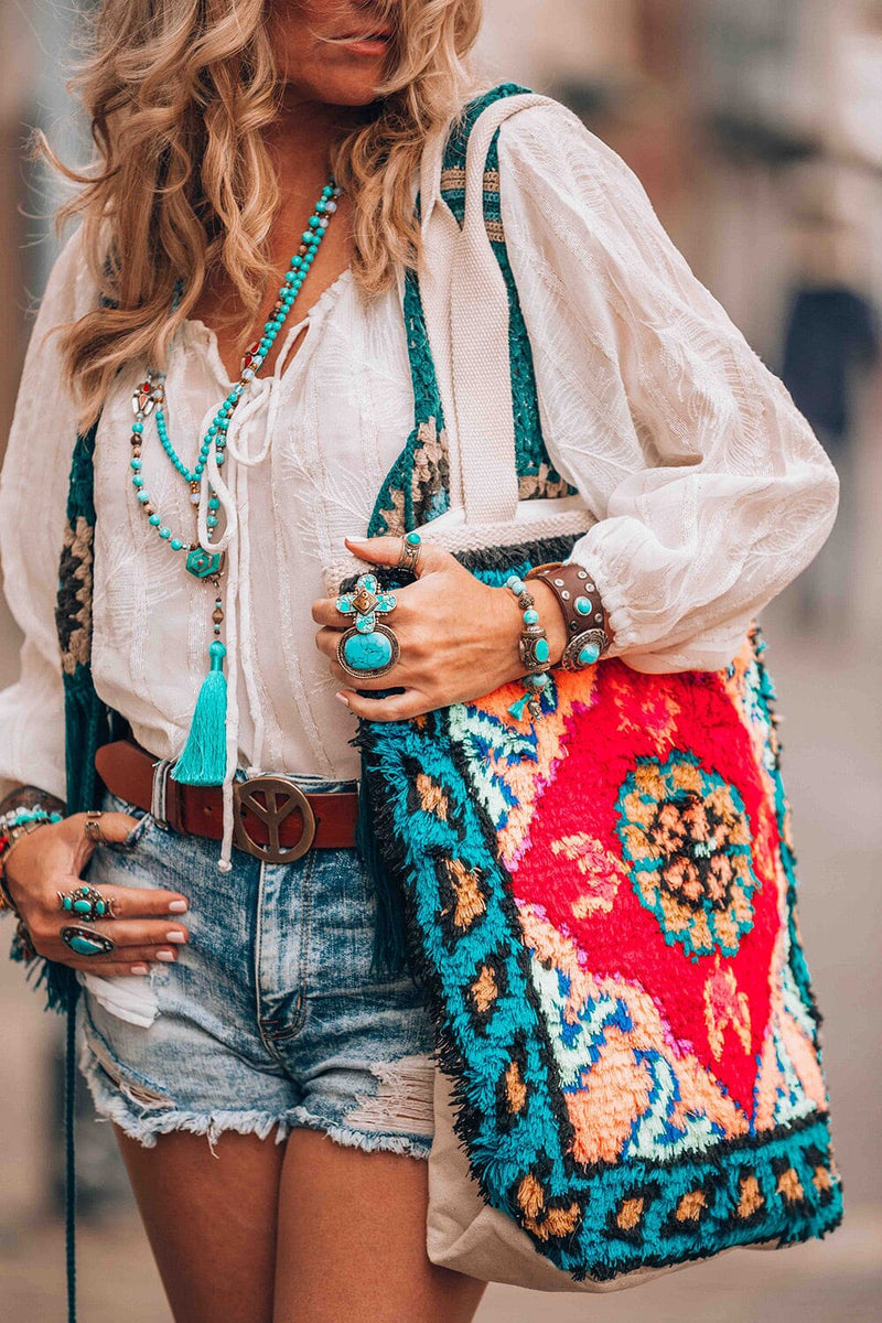 [Color: Red/Teal] A woman holding a bohemian multicolor fuzzy tote bag with a canvas back.