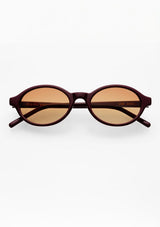 [Color: Burgundy] An image of oval round sunglasses with a burgundy frame and light brown lenses from FREYRS.