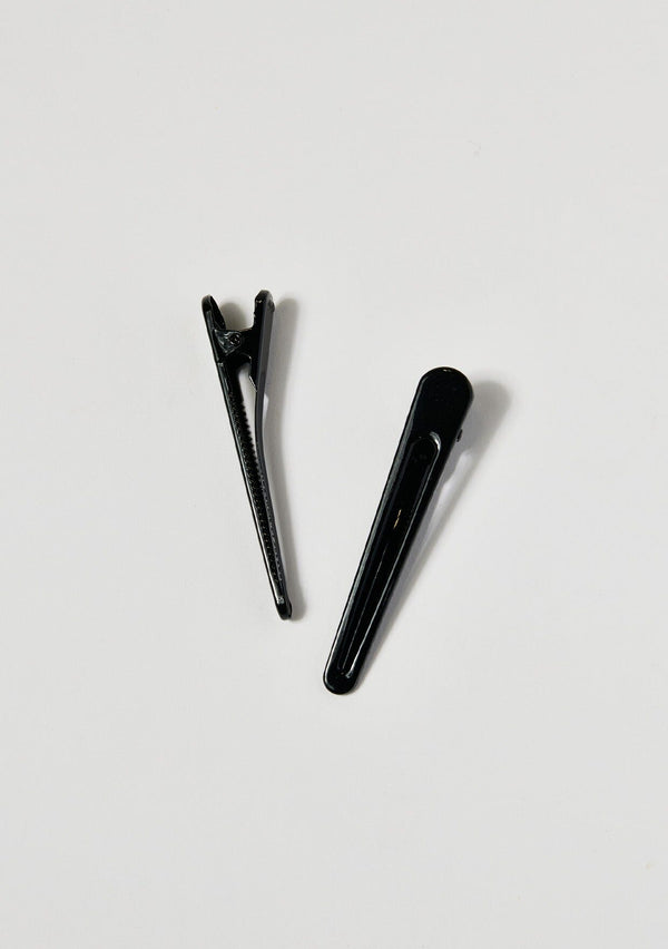 [Color: Black] A set of two black metal hair clips.