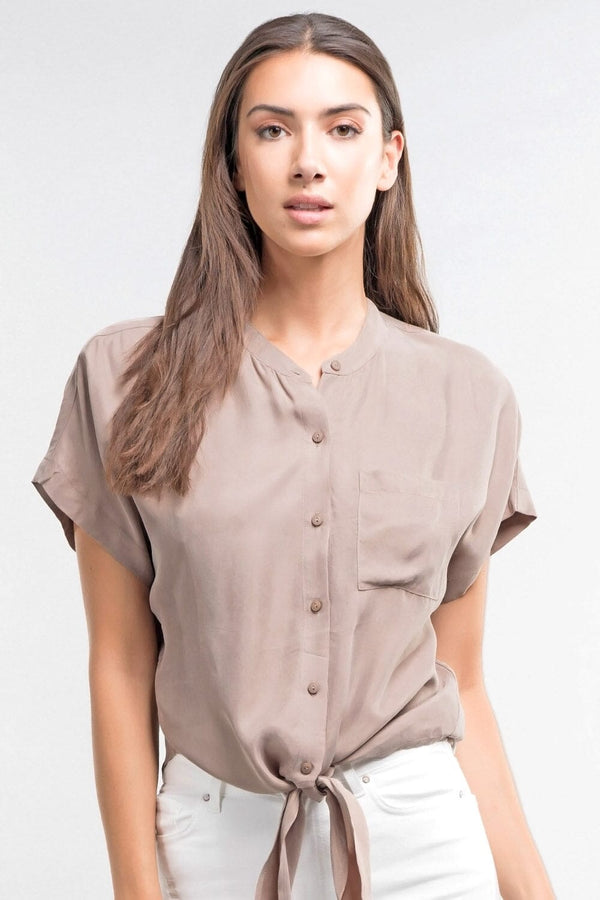 [Color: Mocha] An image of a brunette model wearing a short dolman sleeve top with a button front, single pocket, and tie front detail. 