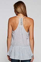[Color: Natural/Denim] A back facing image of a blonde model wearing a striped tank top with a relaxed fit, v-neckline, racerback, and a layered ruffled hem. 
