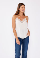 [Color: Vanilla] Girl wearing a ivory lace trim camisole.