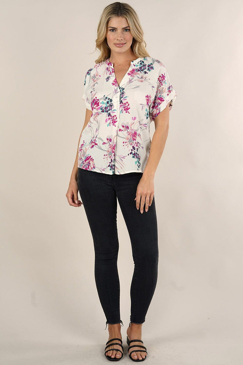 [Color: Ivory/Fuchsia] A front facing image of a blonde model wearing a  cute white and pink button front top with pretty floral print and oversized cuffed sleeves.