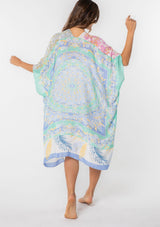 [Color: Sky/Seafoam] A model wearing a stunning mid length kimono in a mixed floral print. Featuring half length kimono sleeves, side slits, and an open front.