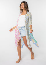 [Color: Sky/Seafoam] A model wearing a stunning mid length kimono in a  mixed floral print. Featuring half length kimono sleeves, side slits, and an open front.