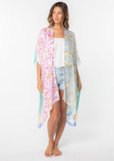 [Color: Sky/Seafoam] A model wearing a stunning mid length kimono in a  mixed floral print. Featuring half length kimono sleeves, side slits, and an open front.