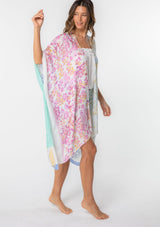 [Color: Sky/Seafoam] A model wearing a stunning mid length kimono in a  mixed floral print. Featuring half length kimono sleeves, side slits, and an open front.