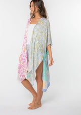 [Color: Sky/Seafoam] A model wearing a stunning mid length kimono in a  mixed floral print. Featuring half length kimono sleeves, side slits, and an open front.