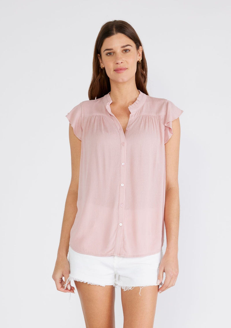 [Color: Dusty Pink] A half body front facing image of a brunette model wearing a soft pink crinkle gauze short sleeve flutter top with a button front and a ruffled neckline.