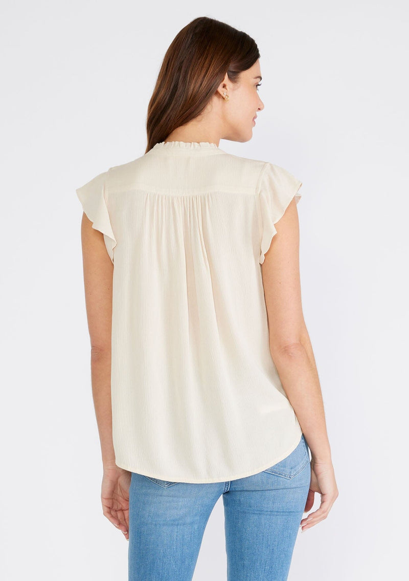 [Color: Natural] A back facing image of a brunette model wearing an off white crinkle gauze short sleeve flutter top with a button front and a ruffled neckline.