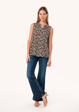 [Color: Black/Teal] A full body front facing image of a blonde model wearing a transitional fall sleeveless blouse in a black and teal floral print. With a button front, a ruffle trimmed neckline, and a relaxed fit. 