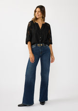 [Color: Black] A front facing image of a brunette model wearing a black lace blouse with a button front, split v-neckline and 3/4 length sleeves. A classic and romantic top for the fall season. 