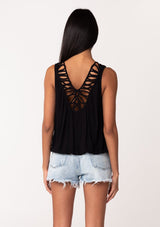 [Color: Black] A back facing image of a brunette model wearing a casual black bohemian summer tank top with a surplice v neckline, an elastic waist, and a back soutache braided detail. 