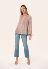 [Color: Rose Water] A full body front facing image of a blonde model wearing a rose pink bohemian blouse. With long sleeves, a v neckline, and pleated shoulder details.