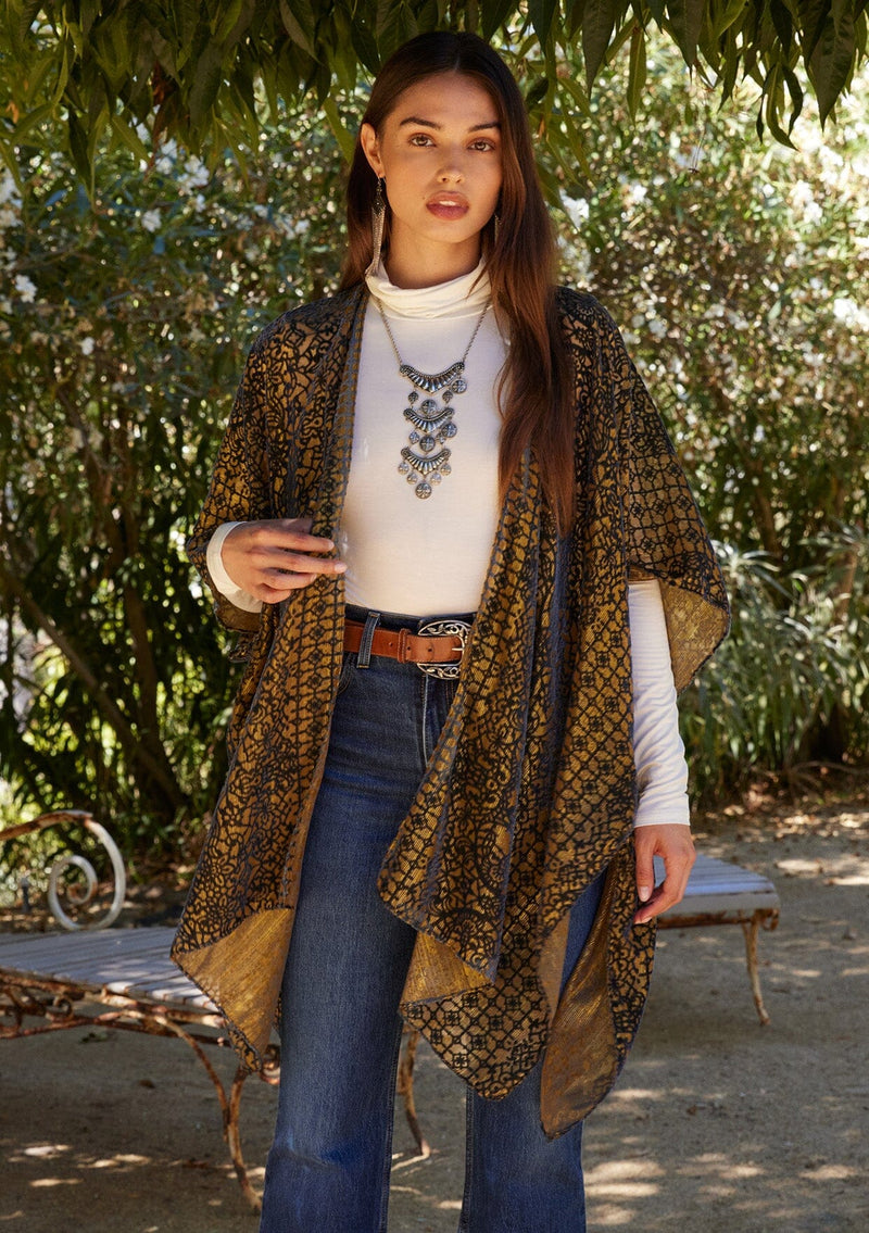 [Color: Gold/Dark Indigo] A close up front facing image of a brunette model wearing a gold bohemian duster kimono with a dark indigo velvet burnout design. A special occasion kimono with half length sleeves and an open front.