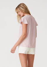 [Color: Dusty Pink] A back facing image of a blonde model wearing a lightweight bohemian resort top  in dusty pink. With short flutter sleeves, a split v neckline with embroidered top stitch details, and a relaxed fit. 