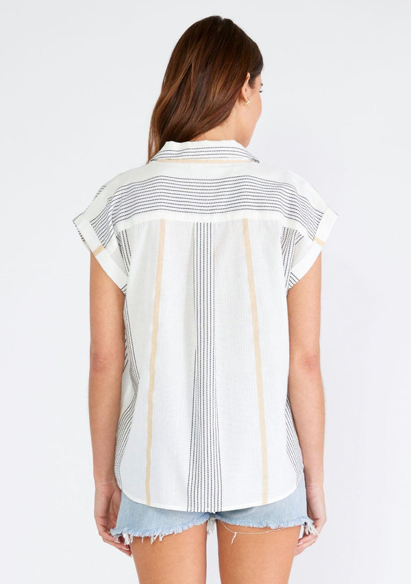 [Color: White/Gold] A back facing image of a brunette model wearing a lightweight short sleeve shirt designed in a textured white and black embroidered and gold metallic stripe. With short cuffed sleeves, a collared neckline, a button front, and a front patch pocket. 