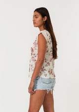 [Color: Natural/Dusty Wine] A side facing image of a brunette model wearing a bohemian resort top in a vintage inspired off white and pink floral print. With a scoop neckline, short cap sleeves, lace trim, pintuck details, and a self covered button up back. 