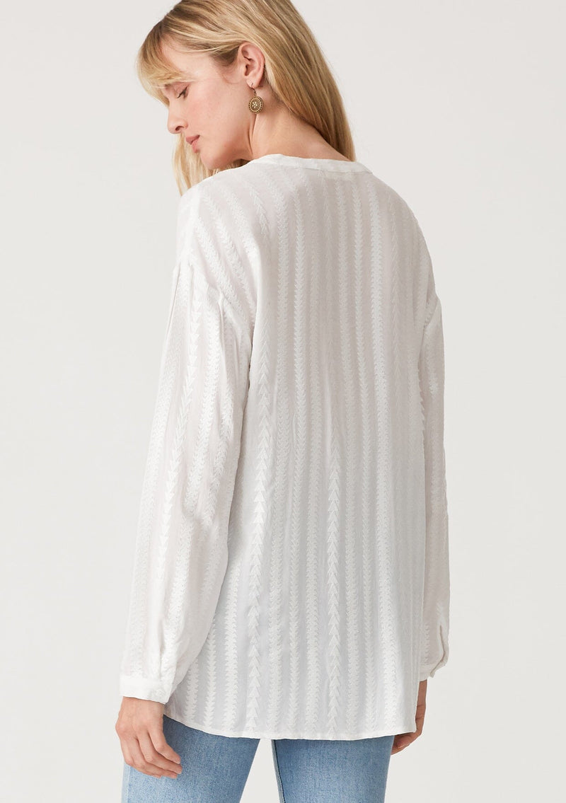 [Color: White] A back facing image of a blonde model wearing a bohemian white shirt with embroidered detail. With long sleeves, a v neckline, a button up front, and a relaxed fit. 