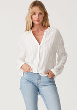 [Color: White] A front facing image of a blonde model wearing a bohemian white shirt with embroidered detail. With long sleeves, a v neckline, a button up front, and a relaxed fit. 