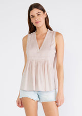 [Color: Mauve] A front facing image of a brunette model wearing a bohemian cotton tank top in a light mauve purple. With a v neckline, a loose, tent silhouette, and pleated details along the front.