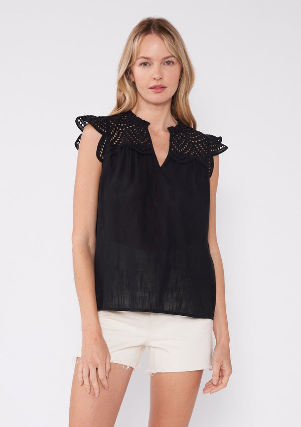 [Color: Black] A front facing image of a brunette model wearing a white bohemian spring top with short cap sleeves, a split v neckline, and an eyelet lace yoke. 