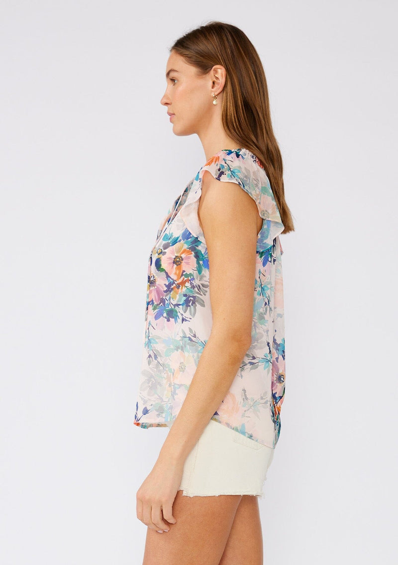 [Color: Peach/Teal] A side facing image of a brunette model wearing a sheer chiffon top in a pink and blue floral print. With short flutter sleeves, a split v neckline with double ties, and pintuck details along the neckline. 