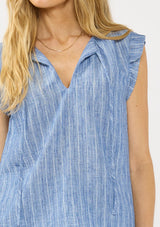 [Color: Blue] A detail image of a blonde model wearing a blue striped top with a split v neckline, ties, and cap sleeves. Styled with a matching bottom. 