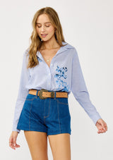 [Color: Camel] A front facing image of a blonde model wearing a vintage-inspired western buckle belt. 