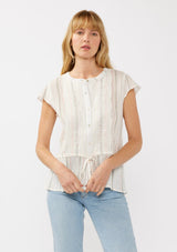 [Color: White/Coral] A front facing image of a blonde model wearing an off white yarn dye stripe top with embroidered eyelet details. This sheer cotton top features a round neckline, button front, short sleeves, and a peplum waist with an adjustable drawstring. Perfect for casual outings and resort styling. 