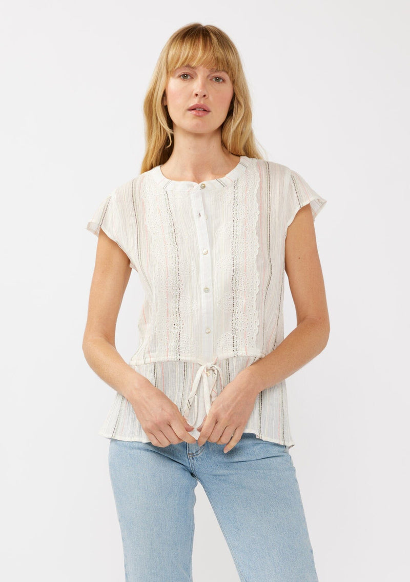 [Color: White/Coral] A front facing image of a blonde model wearing an off white yarn dye stripe top with embroidered eyelet details. This sheer cotton top features a round neckline, button front, short sleeves, and a peplum waist with an adjustable drawstring. Perfect for casual outings and resort styling. 